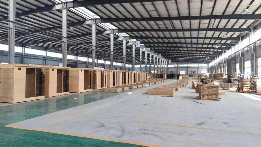 Sauna cabins in series production on the Huian Sauna factory assembly floor, illustrating OEM sauna manufacturing due diligence